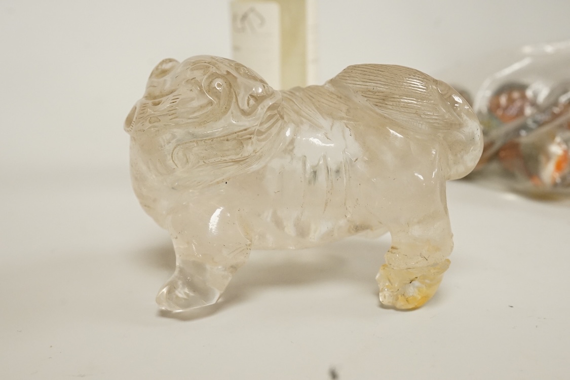 A Chinese carved rock crystal lion, a turquoise bead and a small quantity of marbles, lion 8.5cm wide